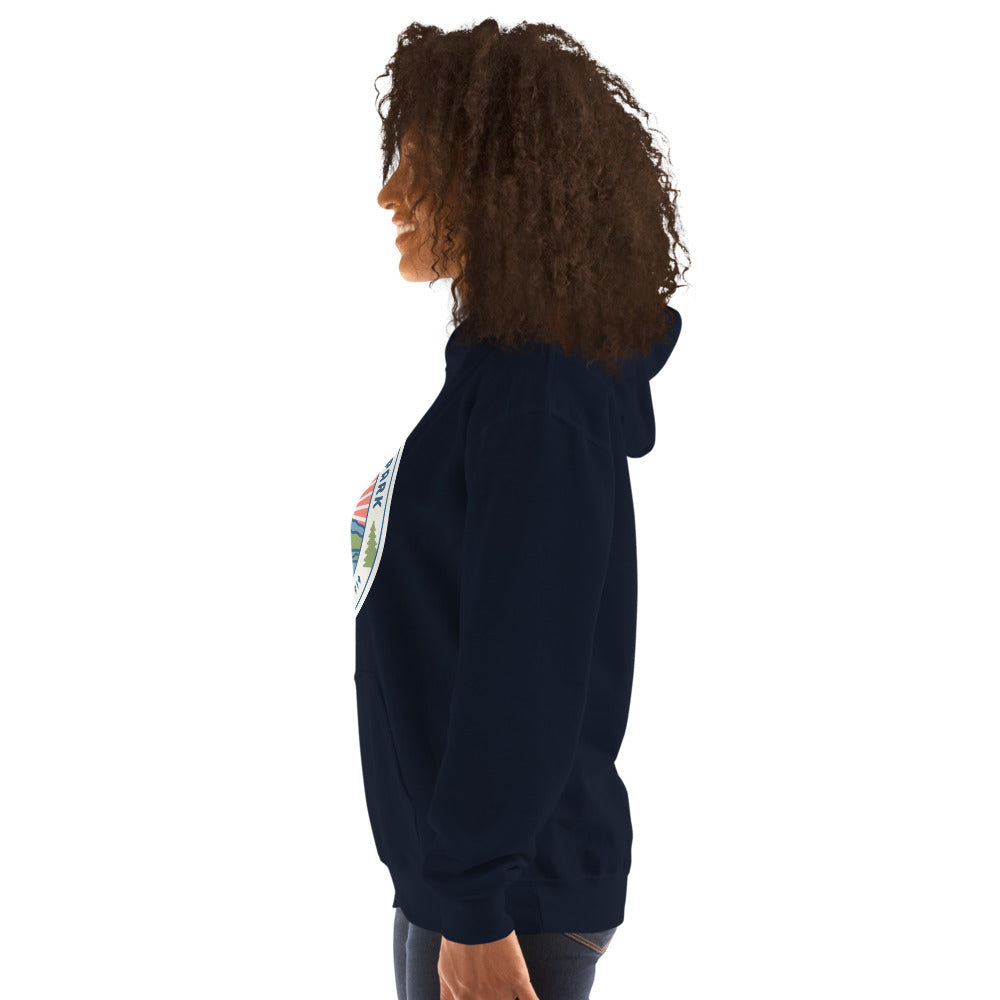 Acadia National Park vintage coastal sunrise badge hoodie in navy worn by a woman, side angle