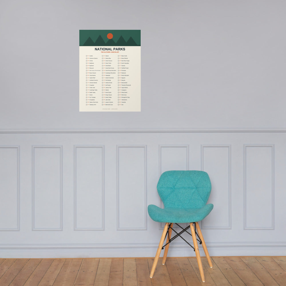 63-park national parks checklist poster on a pale panelled wall above a teal accent chair