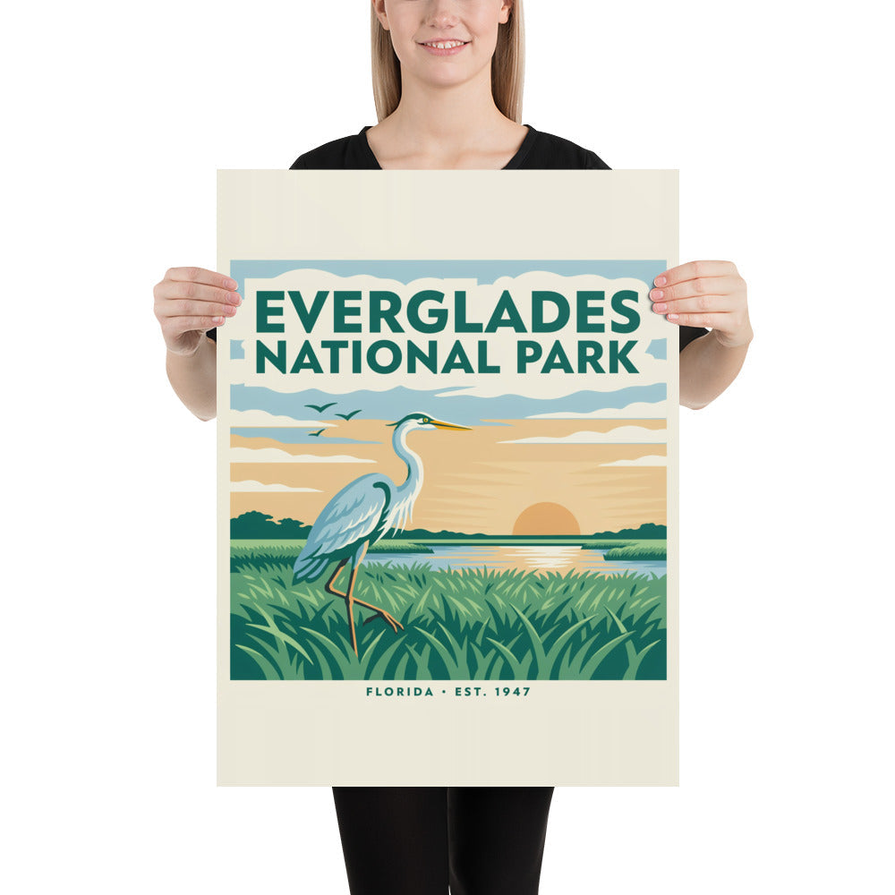 Everglades National Park vintage travel poster with a great blue heron over sawgrass at sunset, held by a person to show scale