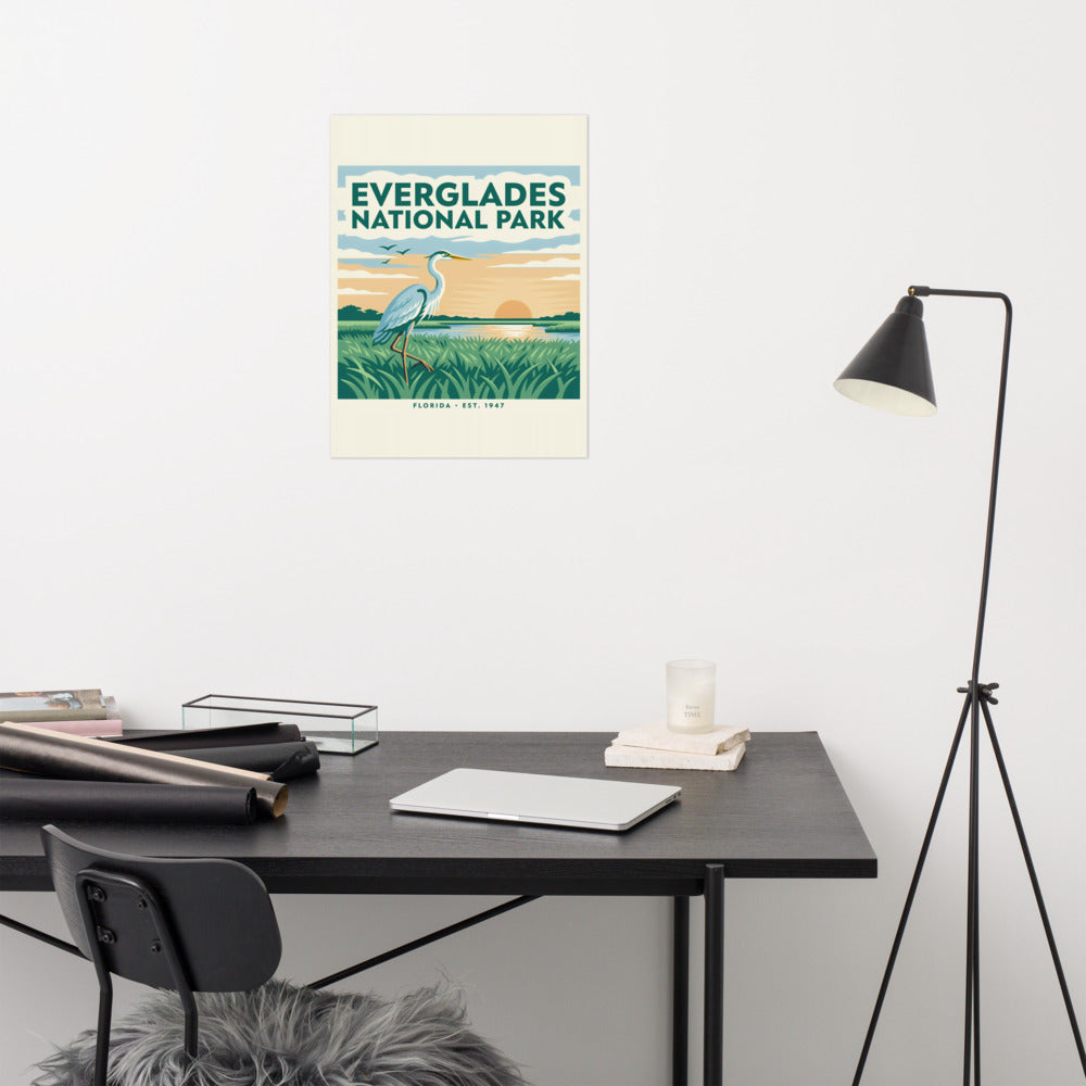 Everglades National Park vintage travel poster with a great blue heron over sawgrass at sunset, hanging above a desk in a home office