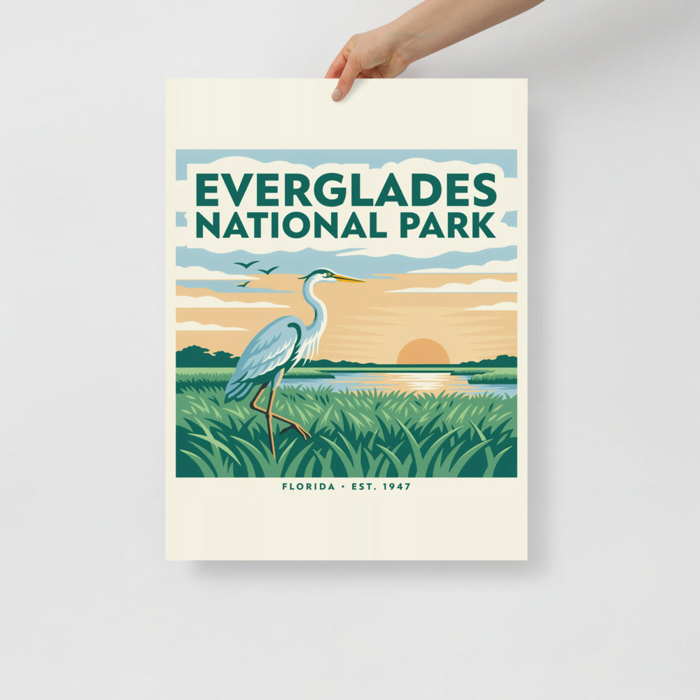 Everglades National Park vintage travel poster with a great blue heron over sawgrass at sunset, held flat against a plain wall