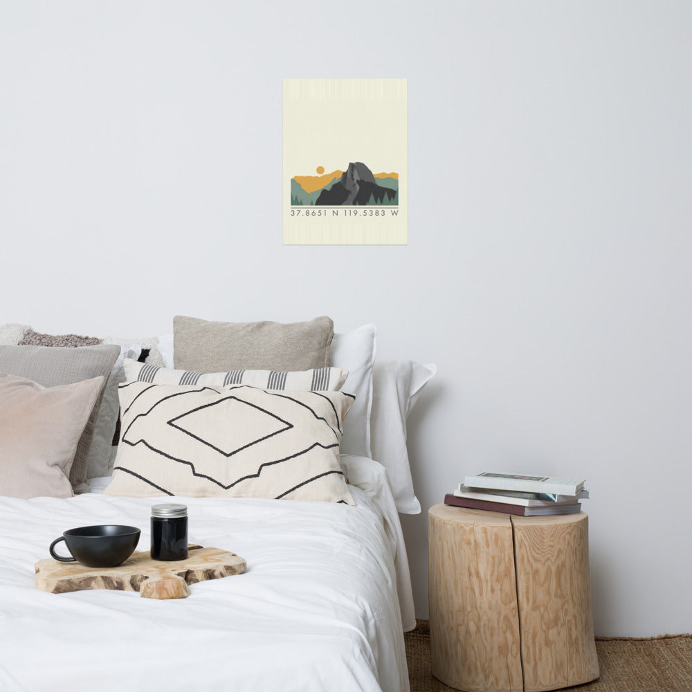 Yosemite coordinates poster with a Half Dome ridgeline and the coordinates 37.8651 N 119.5383 W, hanging above a bed in a styled bedroom