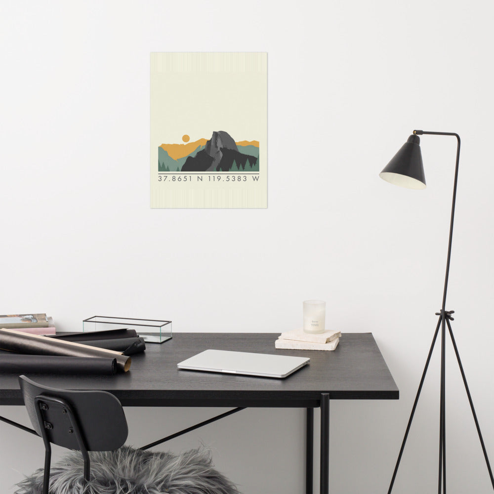 Yosemite coordinates poster with a Half Dome ridgeline and the coordinates 37.8651 N 119.5383 W, hanging above a desk in a home office