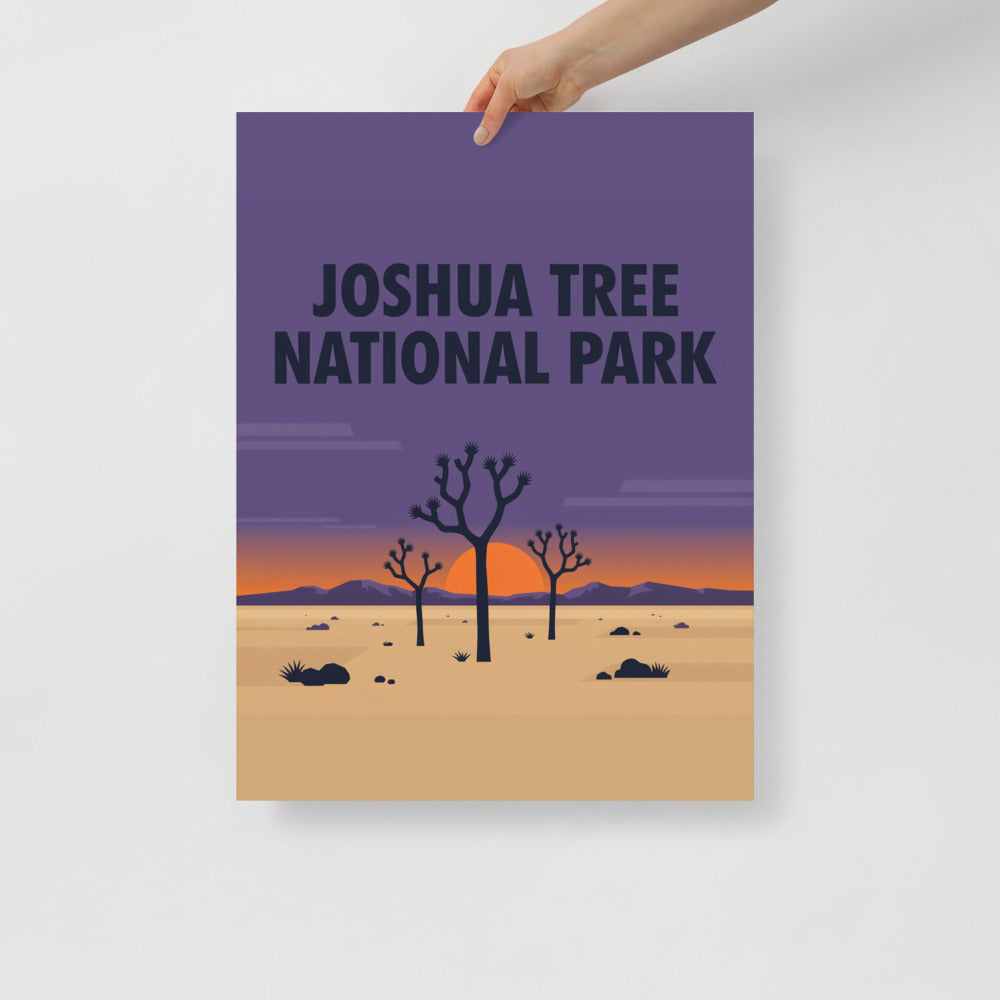 Joshua Tree National Park vintage travel poster held at one corner against a plain wall