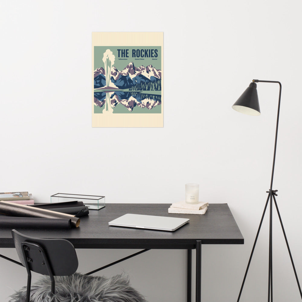 The Rockies vintage travel poster showing Yellowstone, Grand Teton and Glacier as one mountain panorama, hanging above a desk in a home office