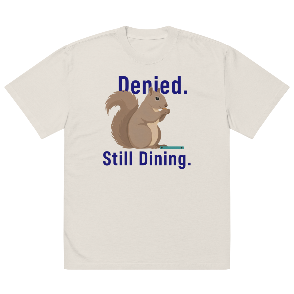 The faded bone squirrel shirt laid flat, showing Denied. Still Dining. around a squirrel eating a seed