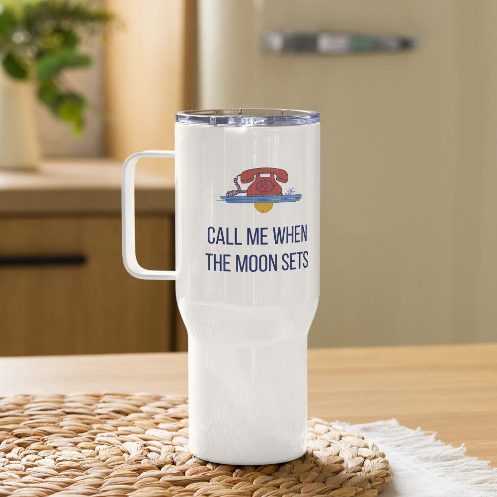 Call Me When the Moon Sets 25 oz astronomy travel mug with red rotary phone and setting moon art on a woven mat in a sunny kitchen