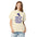 Woman wearing the Ivory lunar observer shirt, front view, printed with binoculars drawn as a ticket casting a long shadow above I CAME FOR CRATERS; STAYED FOR SHADOWS