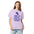 Woman wearing the Orchid lunar observer shirt, front view, printed with binoculars drawn as a ticket casting a long shadow above I CAME FOR CRATERS; STAYED FOR SHADOWS