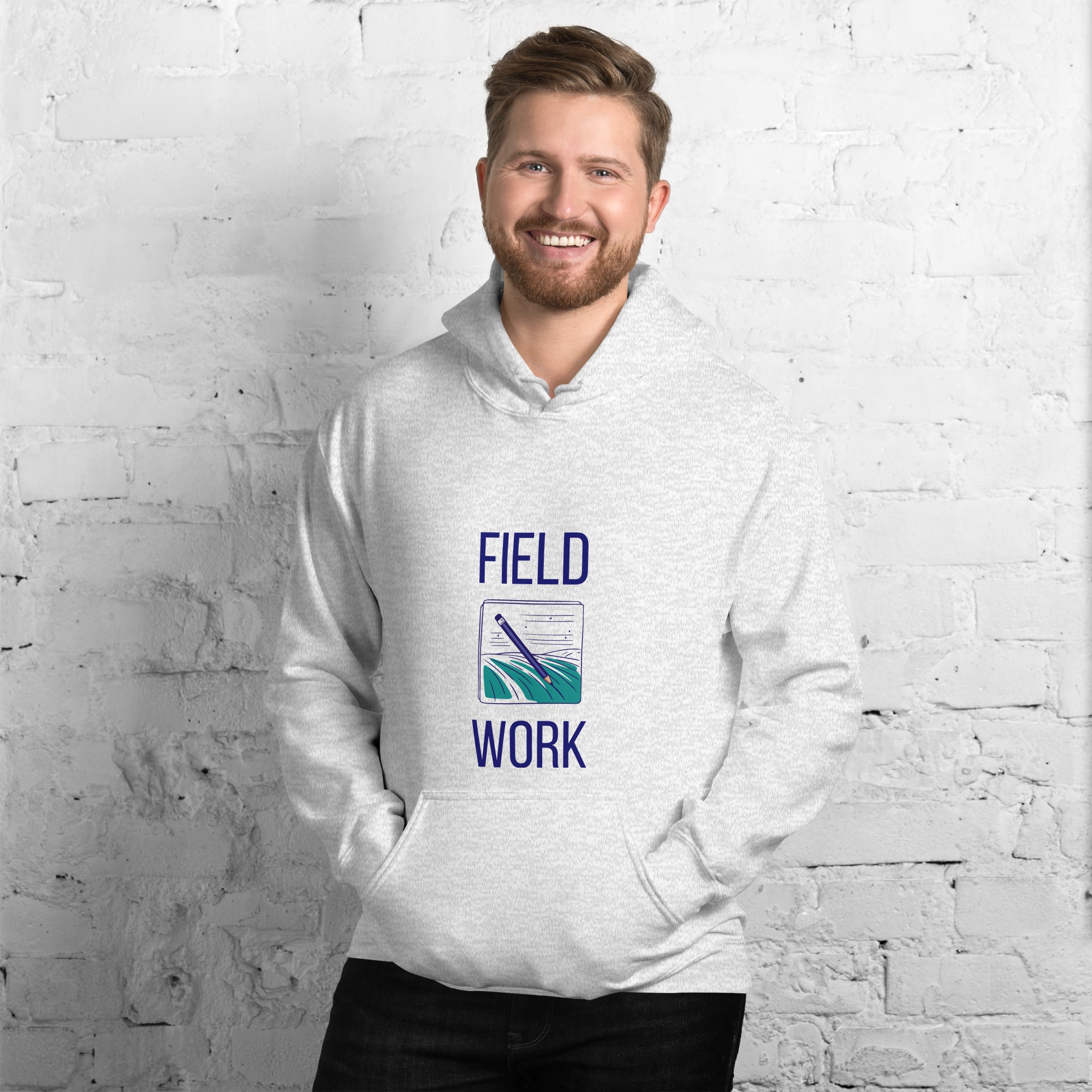 Man in the ash Field Work astronomy hoodie by a white brick wall, front view of the notebook print