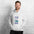 Man in the ash Field Work astronomy hoodie by a white brick wall, front view of the notebook print