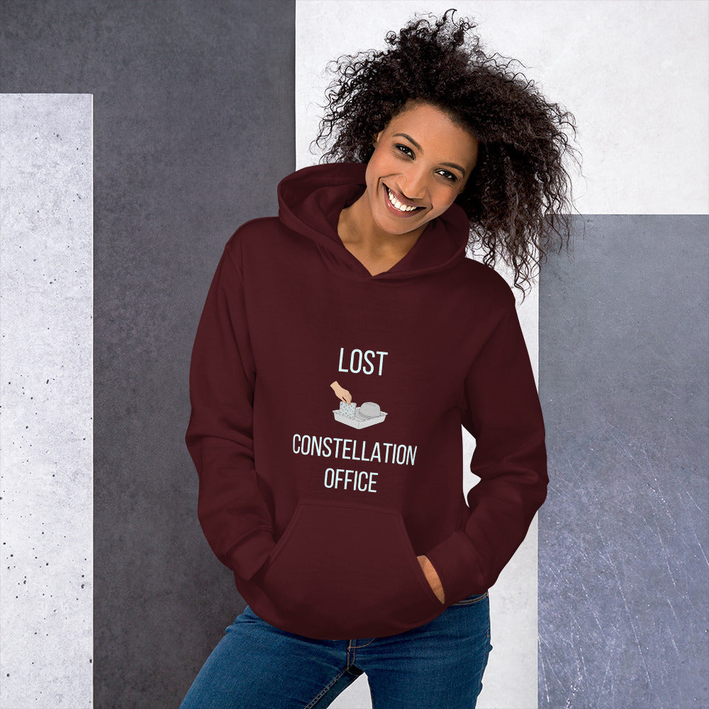 Woman in the maroon Lost Constellation Office constellation hoodie against a grey stone wall