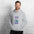 Man in the sport grey Field Work astronomy hoodie by a white brick wall, front view of the notebook print