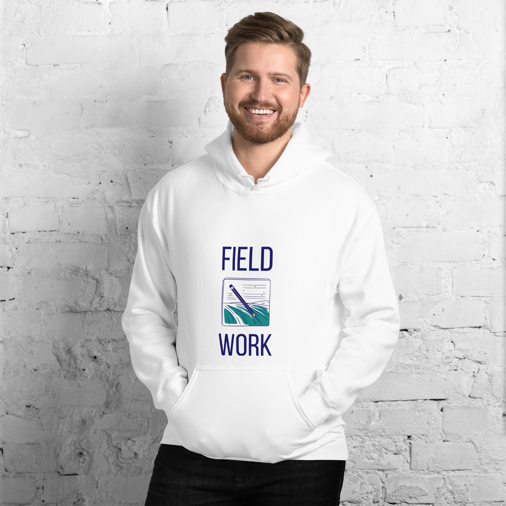 Man in the white Field Work astronomy hoodie by a white brick wall, front view of the notebook print