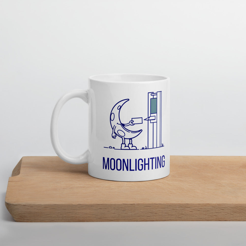 Moonlighting moon mug standing on a wooden board, crescent moon clocking in above the navy MOONLIGHTING lettering