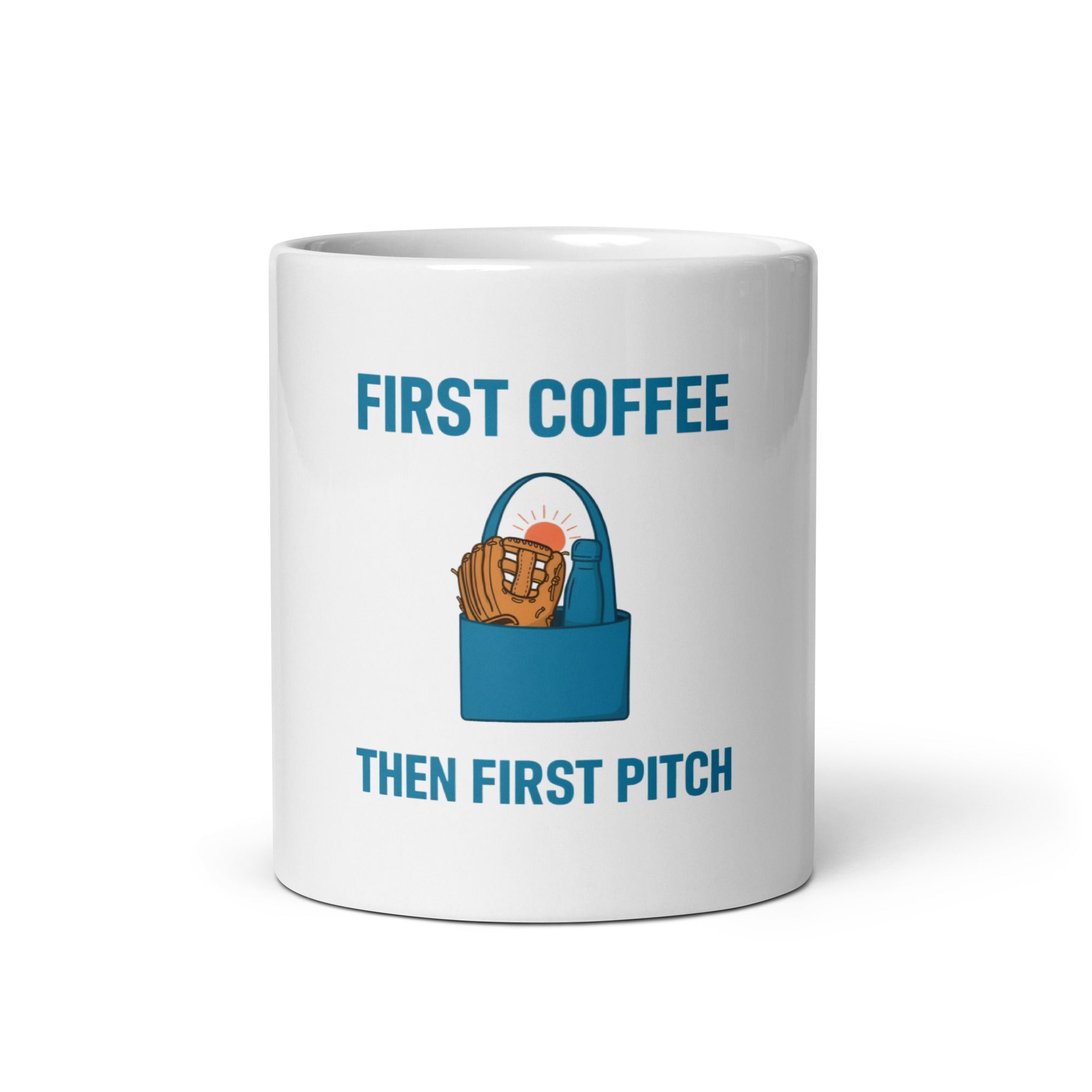 White 11 oz baseball mom mug, front view, with First Coffee, Then First Pitch lettering, a teal tote, glove, flask and sunrise.