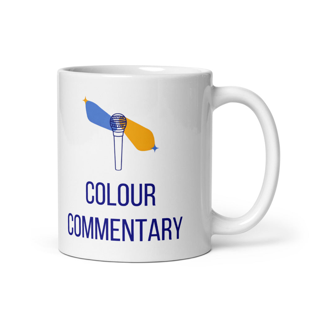 11 oz double star mug, handle on the right, with Colour Commentary in navy under a microphone sending out blue and gold star streaks