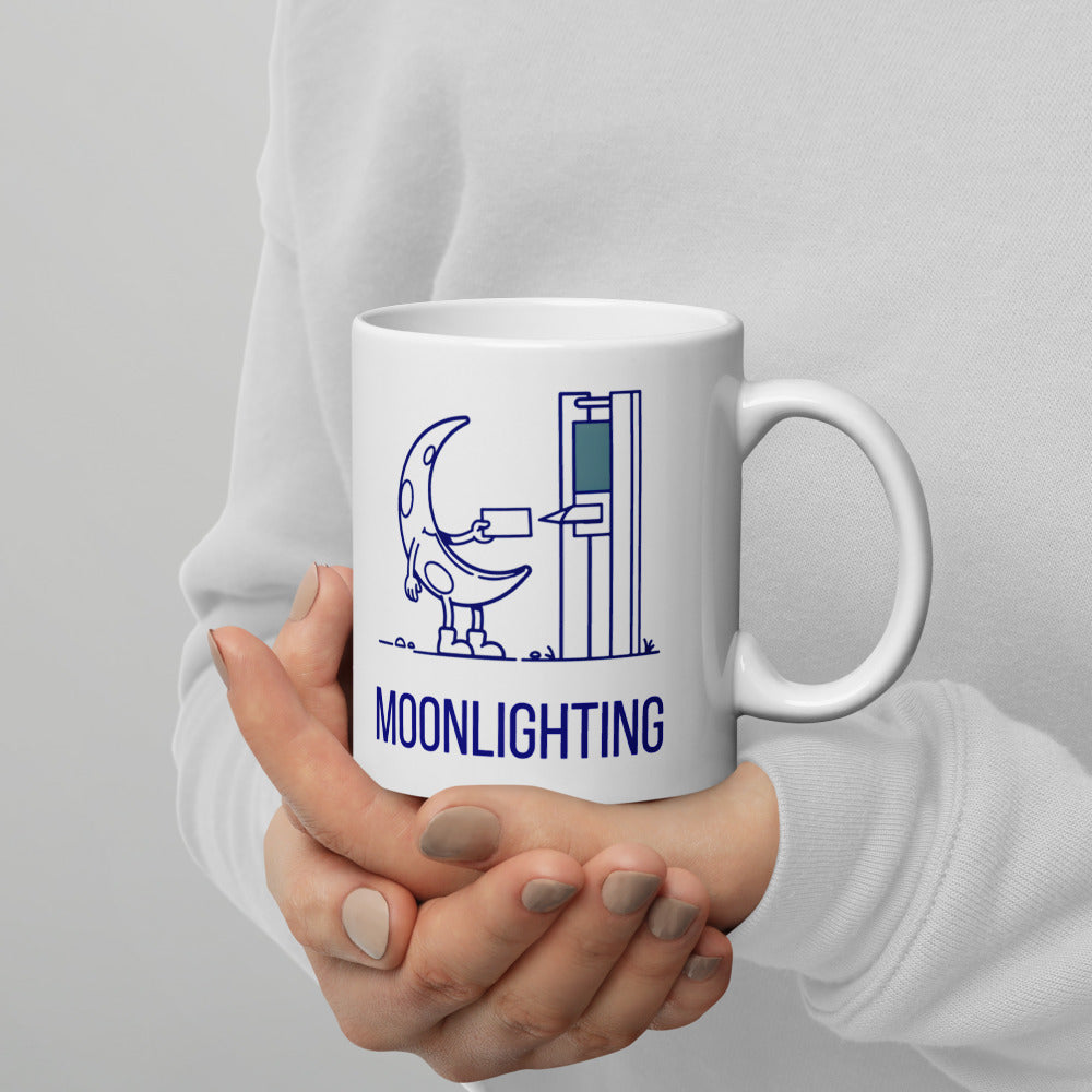 Hands cradling the 11 oz moonlighting mug, the crescent moon slipping its card into the time clock above the navy lettering