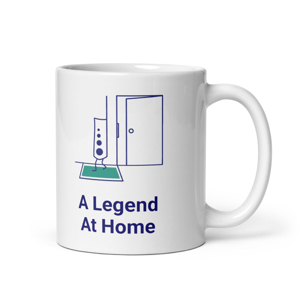 11 oz star atlas mug, handle on the right, with A Legend At Home in navy under a chart legend stepping onto a teal mat
