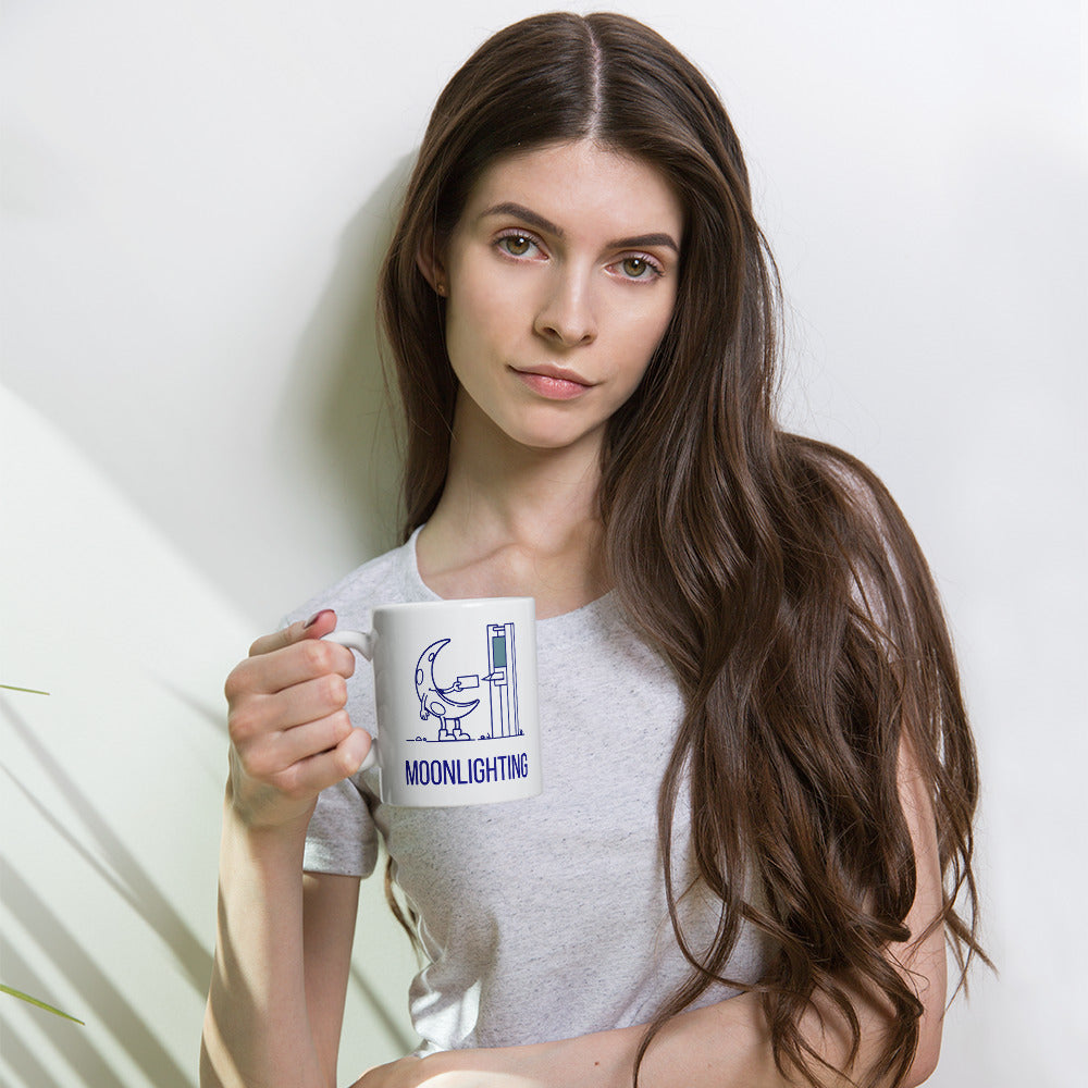 Woman holding the 11 oz moonlighting mug, crescent moon clocking in at a time clock above the navy MOONLIGHTING lettering