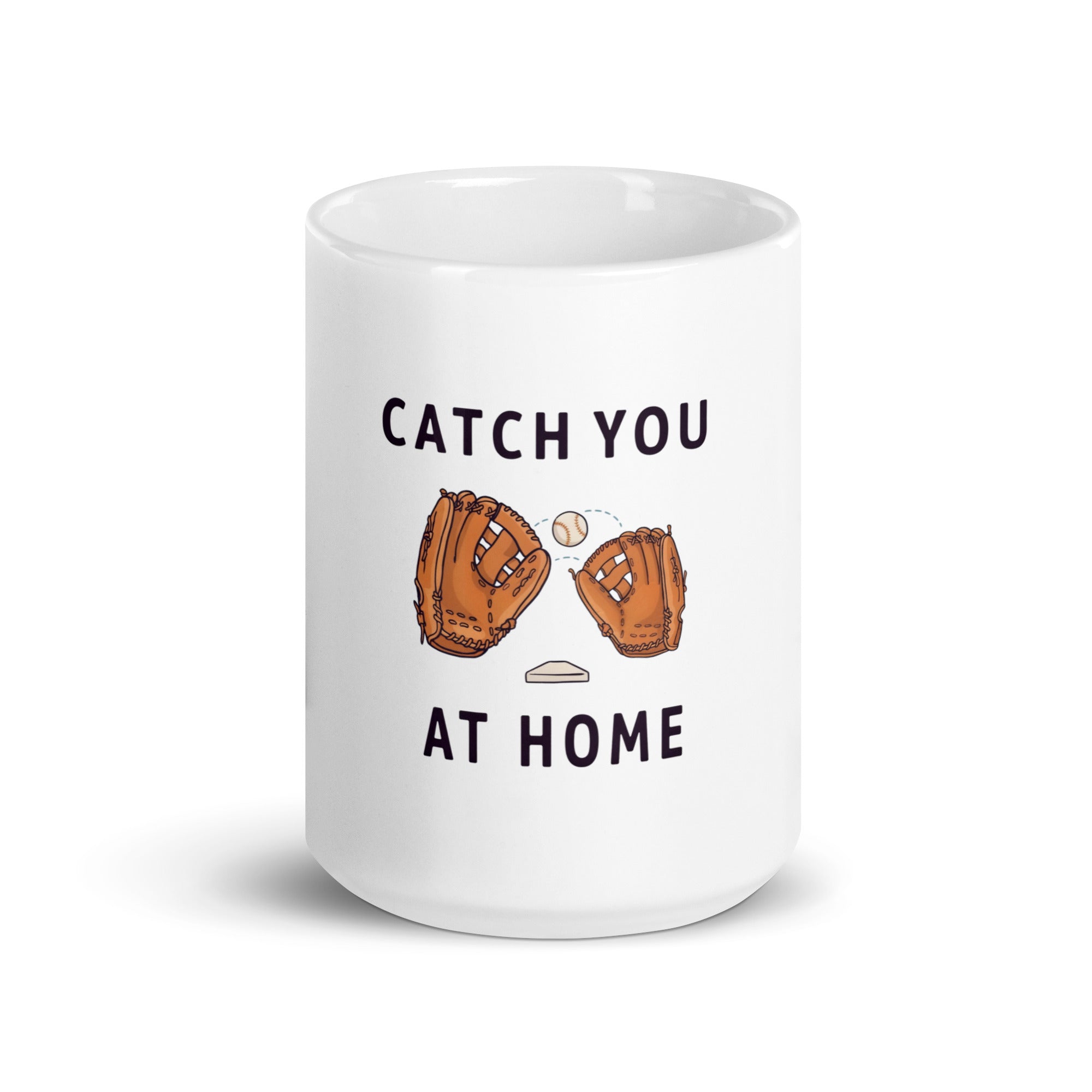 White 15 oz baseball dad mug, front view, with Catch You at Home lettering, two brown gloves, one ball and a home plate.