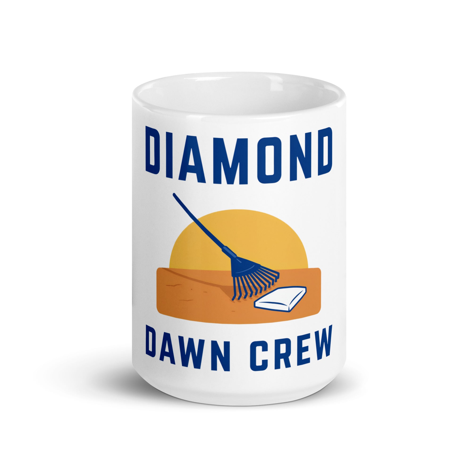 White 15 oz baseball mug with Diamond Dawn Crew lettering, a yellow sunrise, navy rake, orange soil and white home plate; front view.