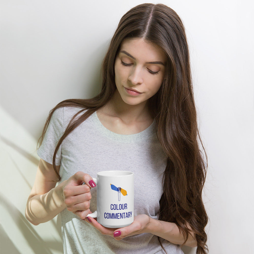 Woman holding the 15 oz Colour Commentary double star mug against a pale wall
