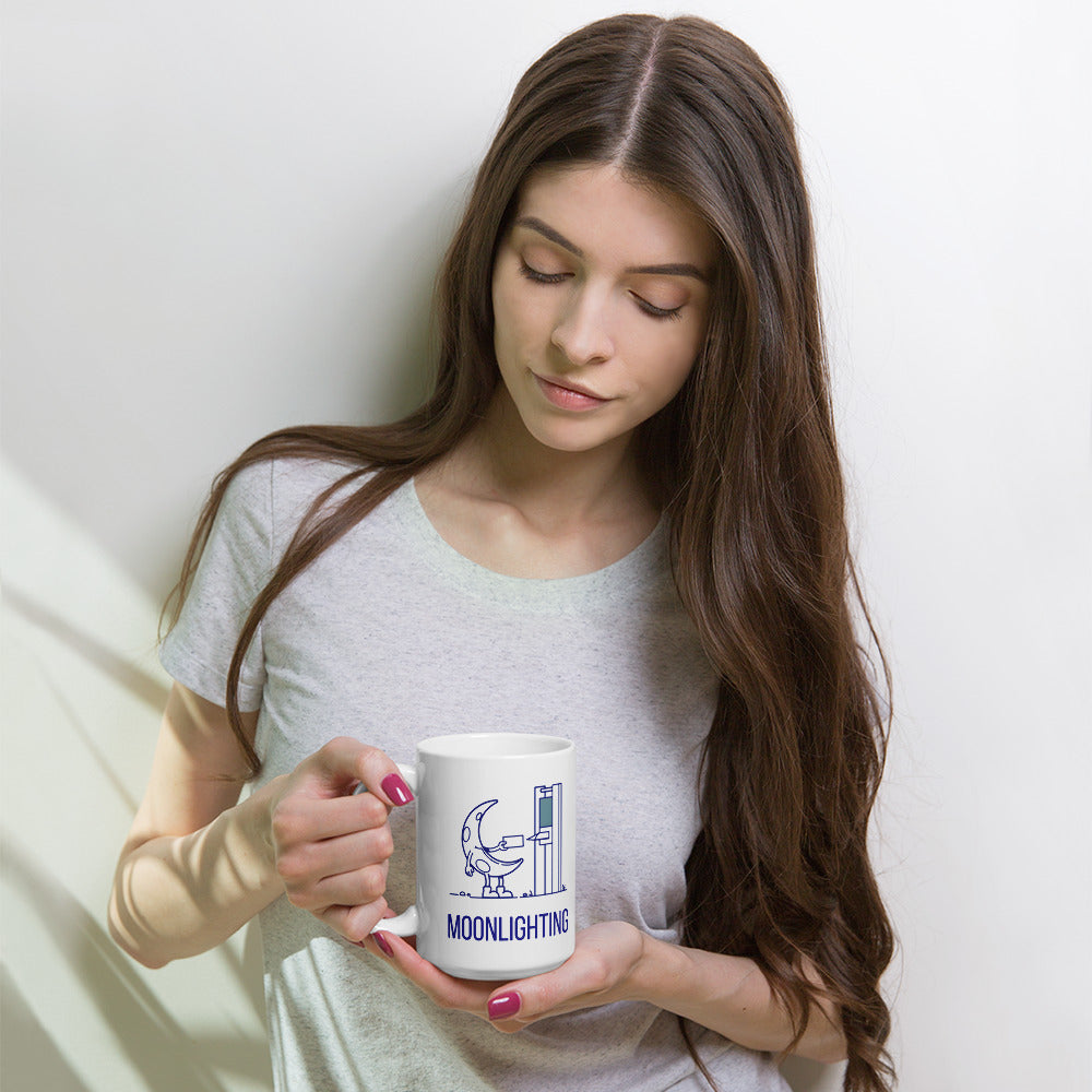 Woman holding the 15 oz moonlighting mug against a pale wall, looking down at the crescent moon design