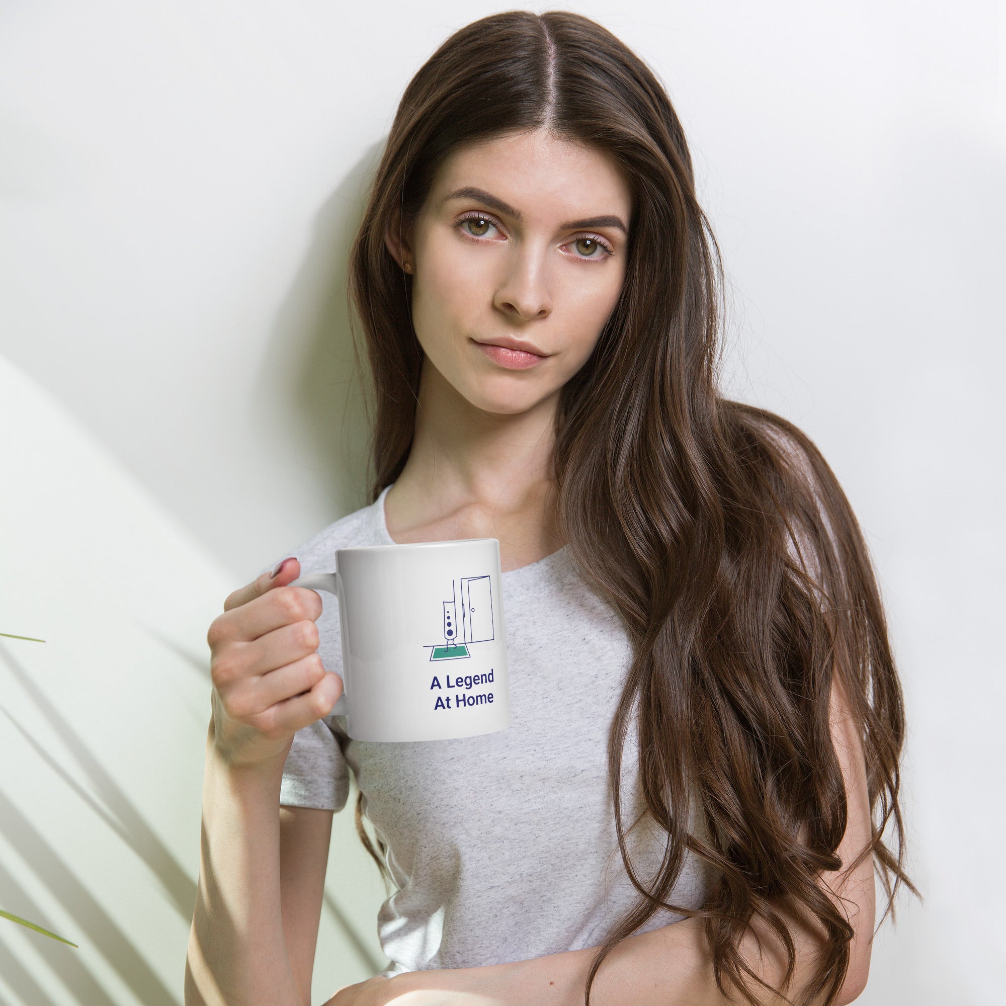 Woman holding the 20 oz A Legend at Home star atlas mug, the widest size
